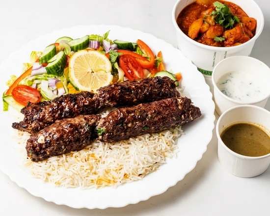 Two skewers of ground beef kebab on saffron basmati rice at Papa Nash's in Airdrie, AB